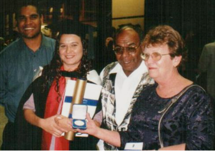 Dr Chelsea Bond  at her 2001 graduation ceremony where she received the University of Queensland medal for academic excellence, with her husband Matthew Bond (left) and parents Vern (now deceased) and Elaine Watego. (Photo supplied by author)