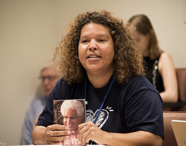 Karina Lester shows the cover of her father's book at the United Nations nuclear weapons ban talks in June: ICAN photo