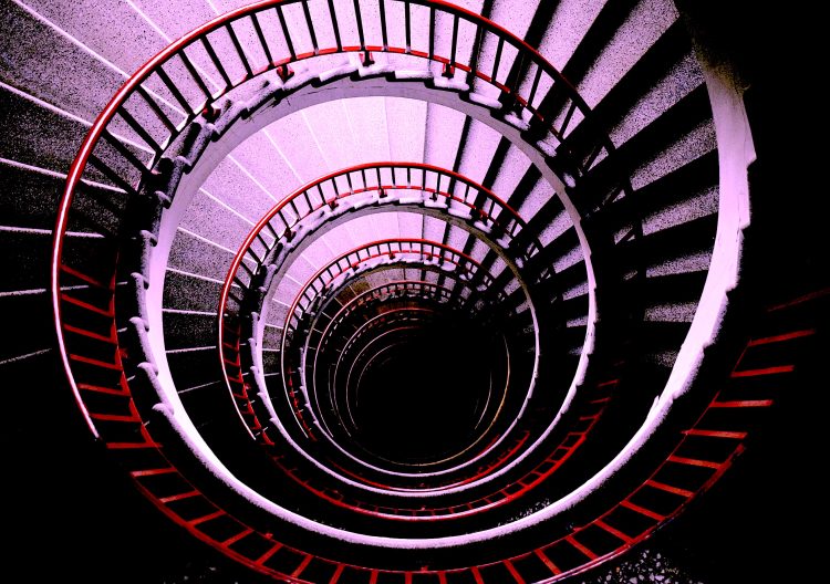 A downward spiral. Photo by Tine Ivanič on Unsplash