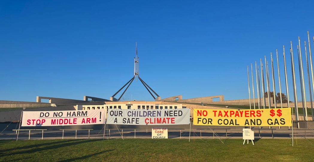 Protest signs outside Parliament House, Canberra, on 8 August 2023. Photo by Jennifer Doggett